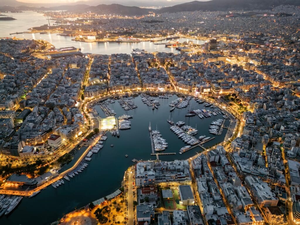 Aerial view of the illuminated Zea Marina in Piraeus, Athens, Greece, with lined up sailing boats and yachts during evening