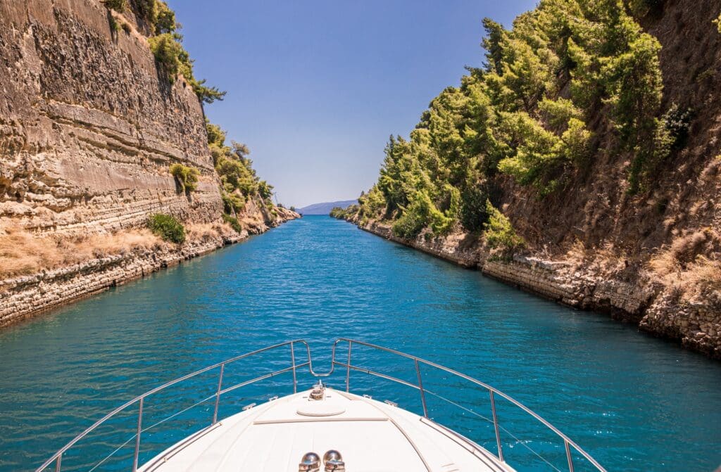 Passing through the Corinth Canal by yacht, Greece. The Corinth Canal connects the Gulf of Corinth with the Saronic Gulf in the Aegean Sea. Horizontal.